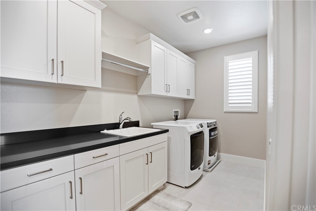 63 Crater Irvine, CA 92618 - Photo 27 of 34 a kitchen with white cabinets and white appliances