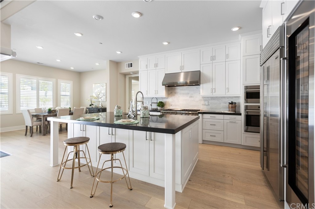 63 Crater Irvine, CA 92618 - Photo 4 of 34 a kitchen with stainless steel appliances kitchen island granite countertop a refrigerator and a stove top oven