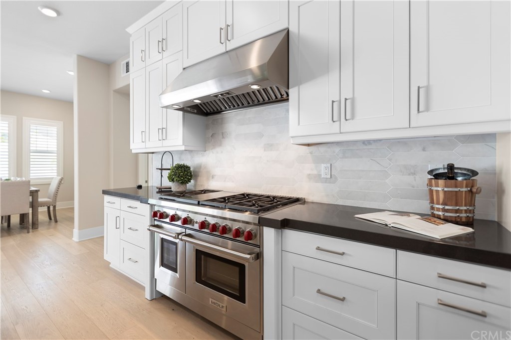 63 Crater Irvine, CA 92618 - Photo 9 of 34 a kitchen with stainless steel appliances granite countertop white cabinets a stove a sink and dishwasher