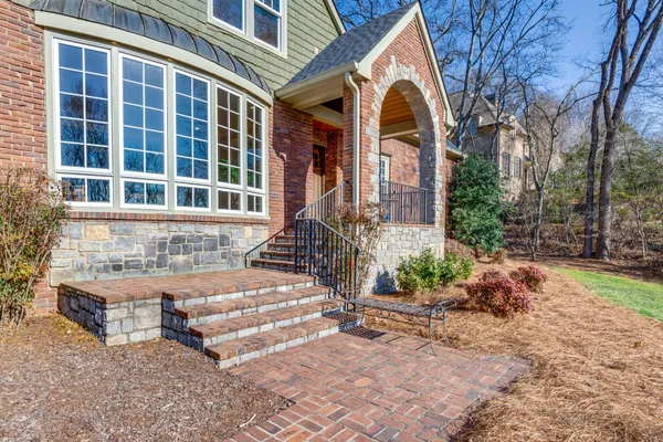 a front view of a house with garden and plants