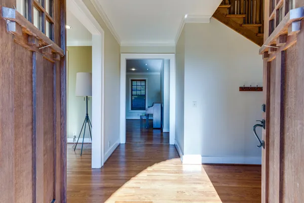 a view of entryway and hall with wooden floor