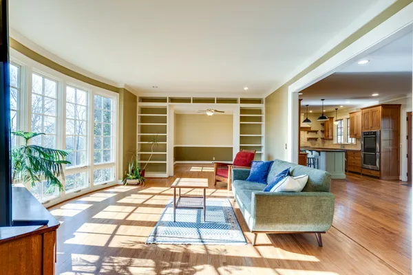 a living room with furniture and a wooden floor