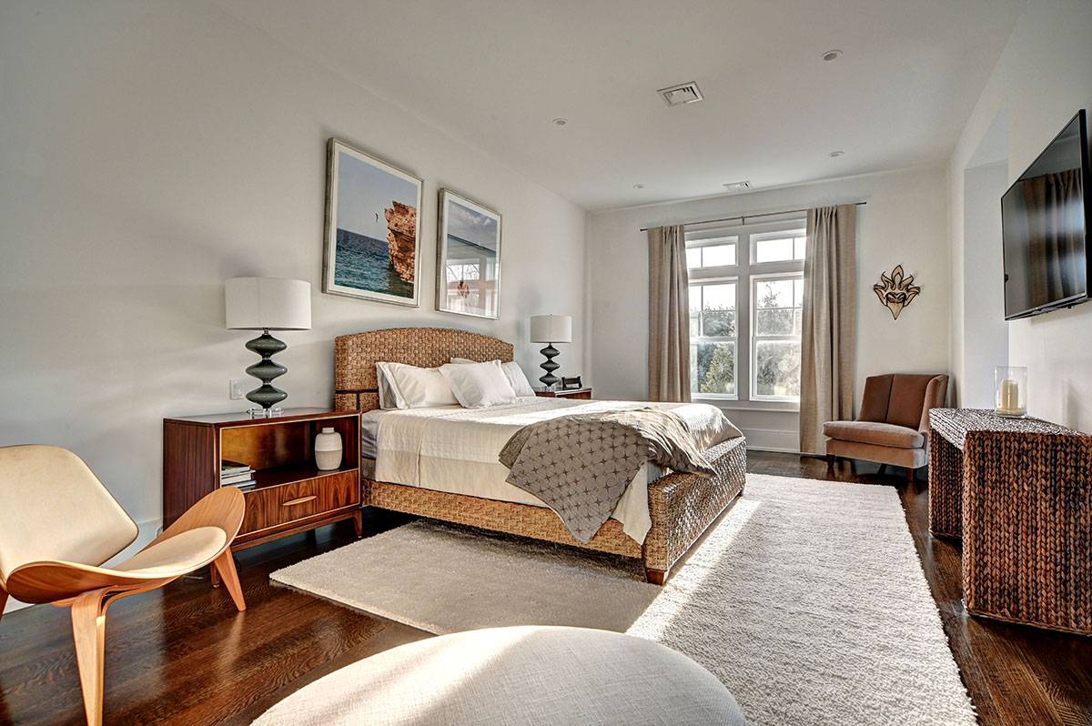 63 Newlight Lane Bridgehampton, NY 11976 - Photo 22 of 37 a bedroom with a bed and glass windows