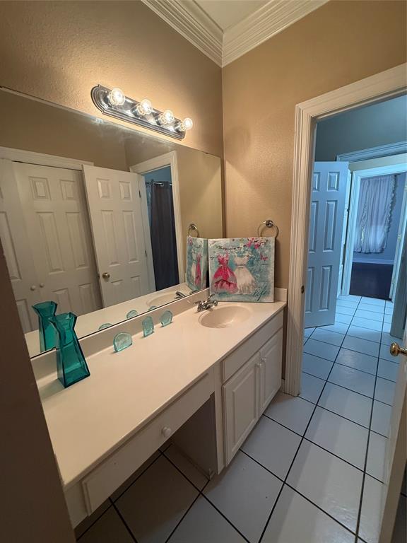 201 Woodhaven Drive Minden, LA 71055 - Photo 20 of 31 Bathroom vanity featuring a single integrated sink, white cabinetry with a built-in knee space, and a large wall-mounted mirror