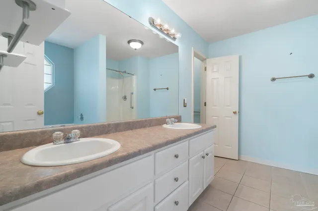 an empty room with a chandelier fan and closet area