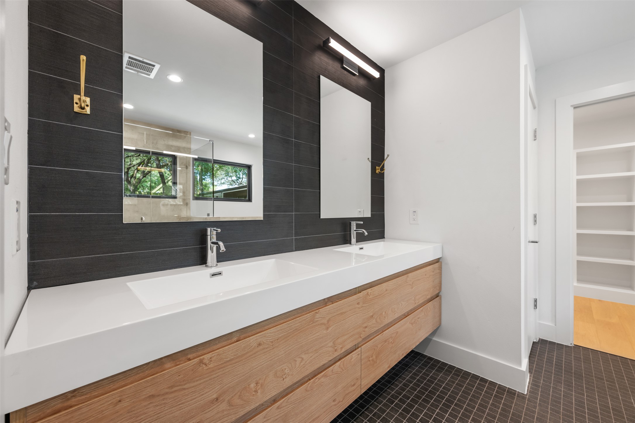 8900 Point W Drive Austin, TX 78759 - Photo 25 of 40 A modern primary bath features a dual vanity and sleek tile flooring.