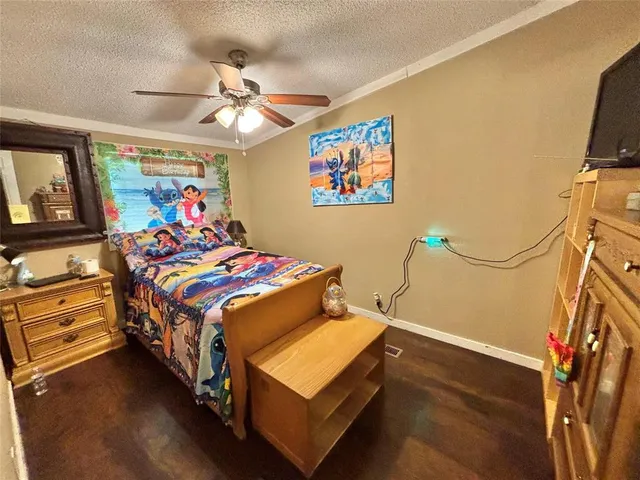 a bedroom with bed and wooden floor