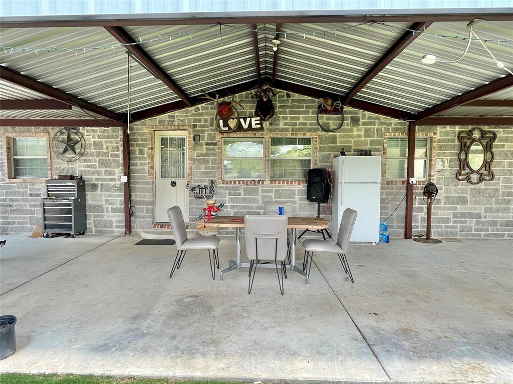 119 Overlook Trail Azle, TX 76020 - Photo 8 of 20 a view of a patio with table and chairs and potted plants