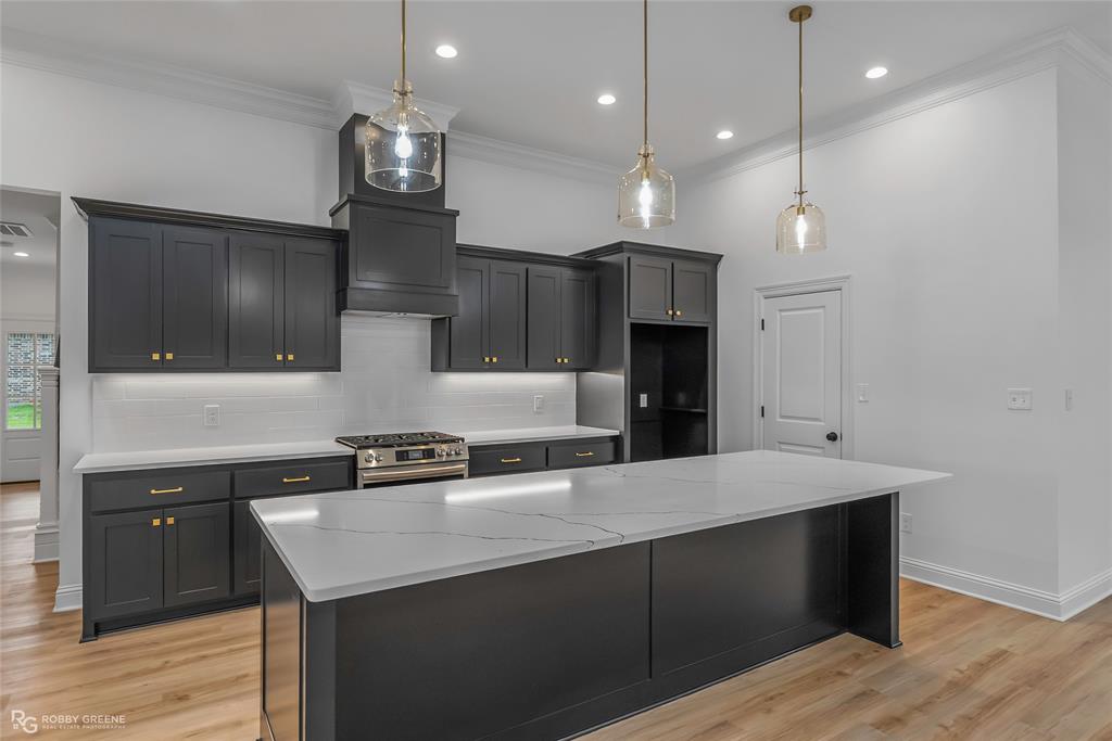 231 Ramsey Road Stonewall, LA 71078 - Photo 13 of 39 a kitchen with kitchen island a sink stainless steel appliances and cabinets