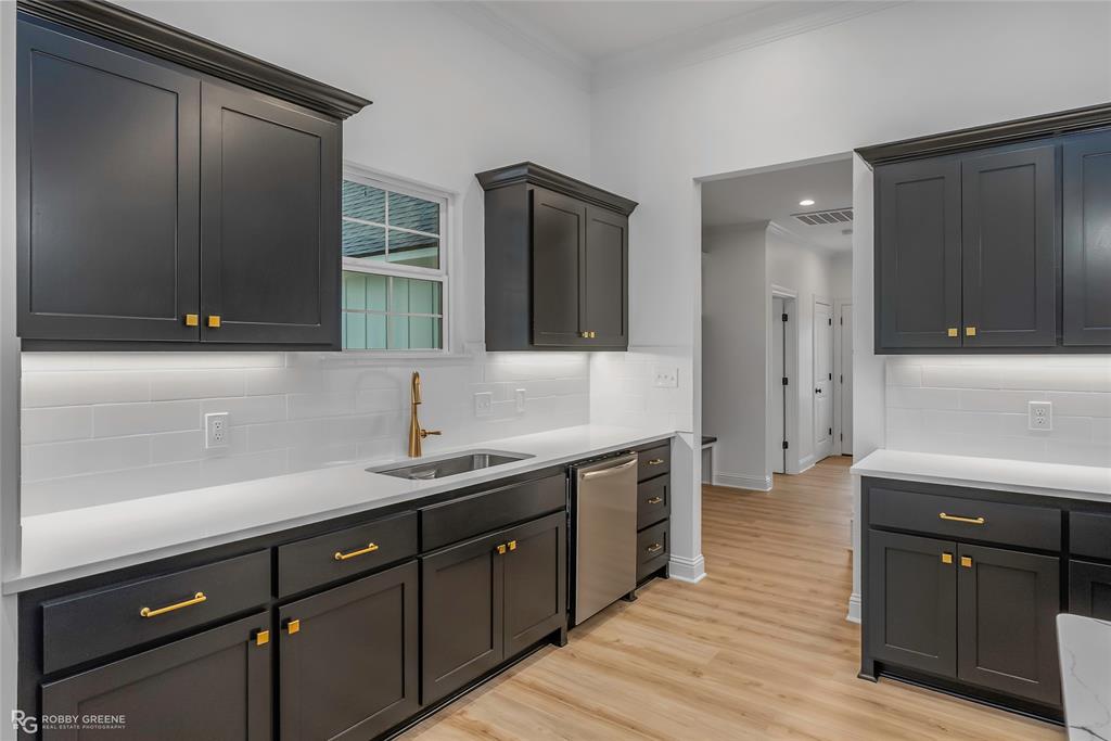 231 Ramsey Road Stonewall, LA 71078 - Photo 14 of 39 a kitchen with stainless steel appliances granite countertop a sink and wooden cabinets