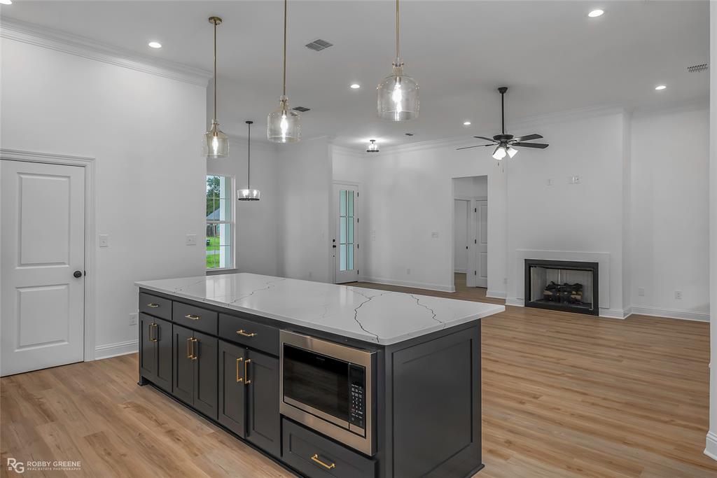 231 Ramsey Road Stonewall, LA 71078 - Photo 15 of 39 a kitchen with a stove and a wooden floor