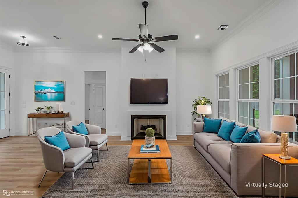 231 Ramsey Road Stonewall, LA 71078 - Photo 2 of 39 a living room with furniture a flat screen tv and a fireplace