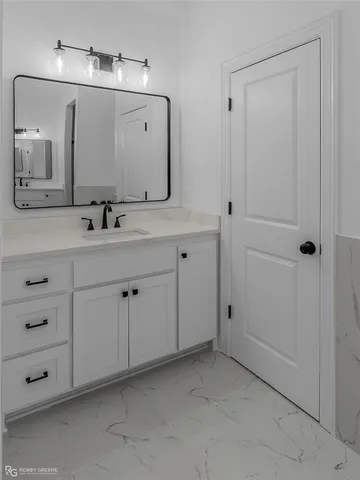 a bathroom with a double vanity sink and mirror
