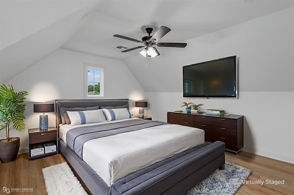 231 Ramsey Road Stonewall, LA 71078 - Photo 28 of 39 a bedroom with a bed and a flat screen tv