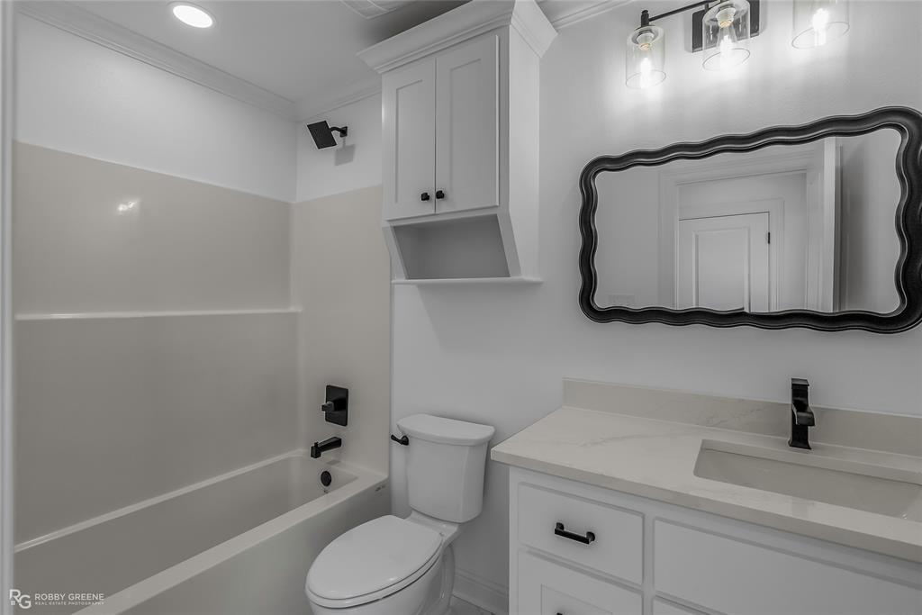 231 Ramsey Road Stonewall, LA 71078 - Photo 33 of 39 a bathroom with a sink a toilet and shower