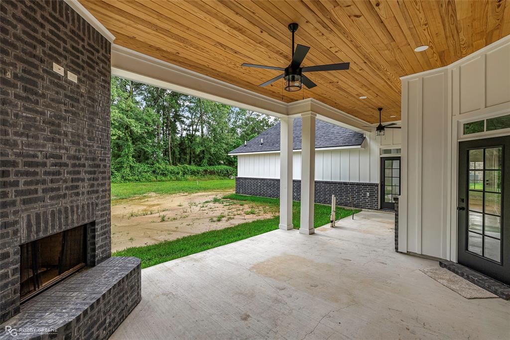 231 Ramsey Road Stonewall, LA 71078 - Photo 36 of 39 a view of a porch with furniture and garden
