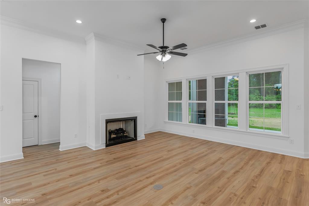 231 Ramsey Road Stonewall, LA 71078 - Photo 4 of 39 a view of an empty room with a window and wooden floor