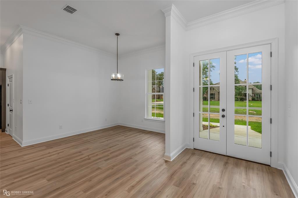 231 Ramsey Road Stonewall, LA 71078 - Photo 6 of 39 an empty room with wooden floor and windows