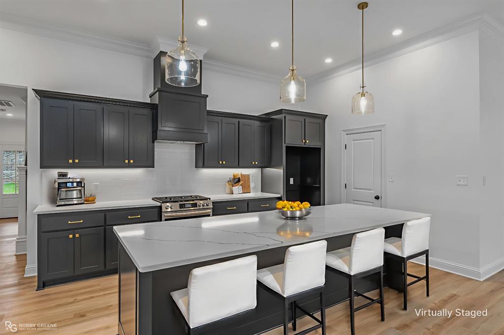 231 Ramsey Road Stonewall, LA 71078 - Photo 8 of 39 a kitchen with granite countertop a table chairs stainless steel appliances and cabinets