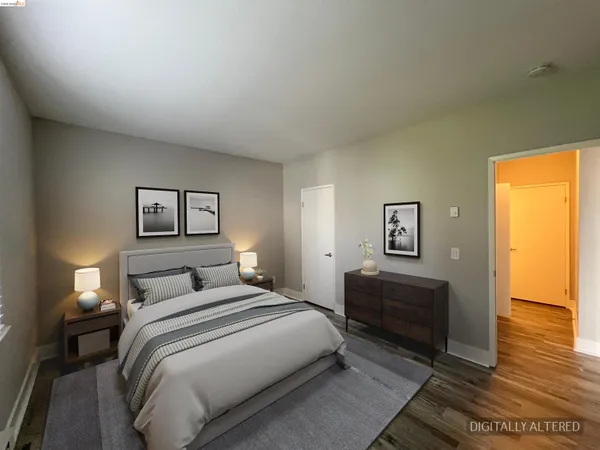 a bedroom with a bed and a painting on the wall