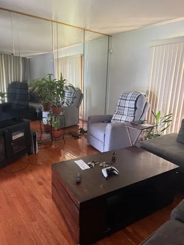 a living room with furniture and wooden floor
