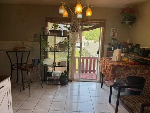 a dining room with furniture and a floor to ceiling window
