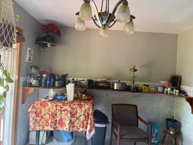 a room with a table chairs and wooden floor