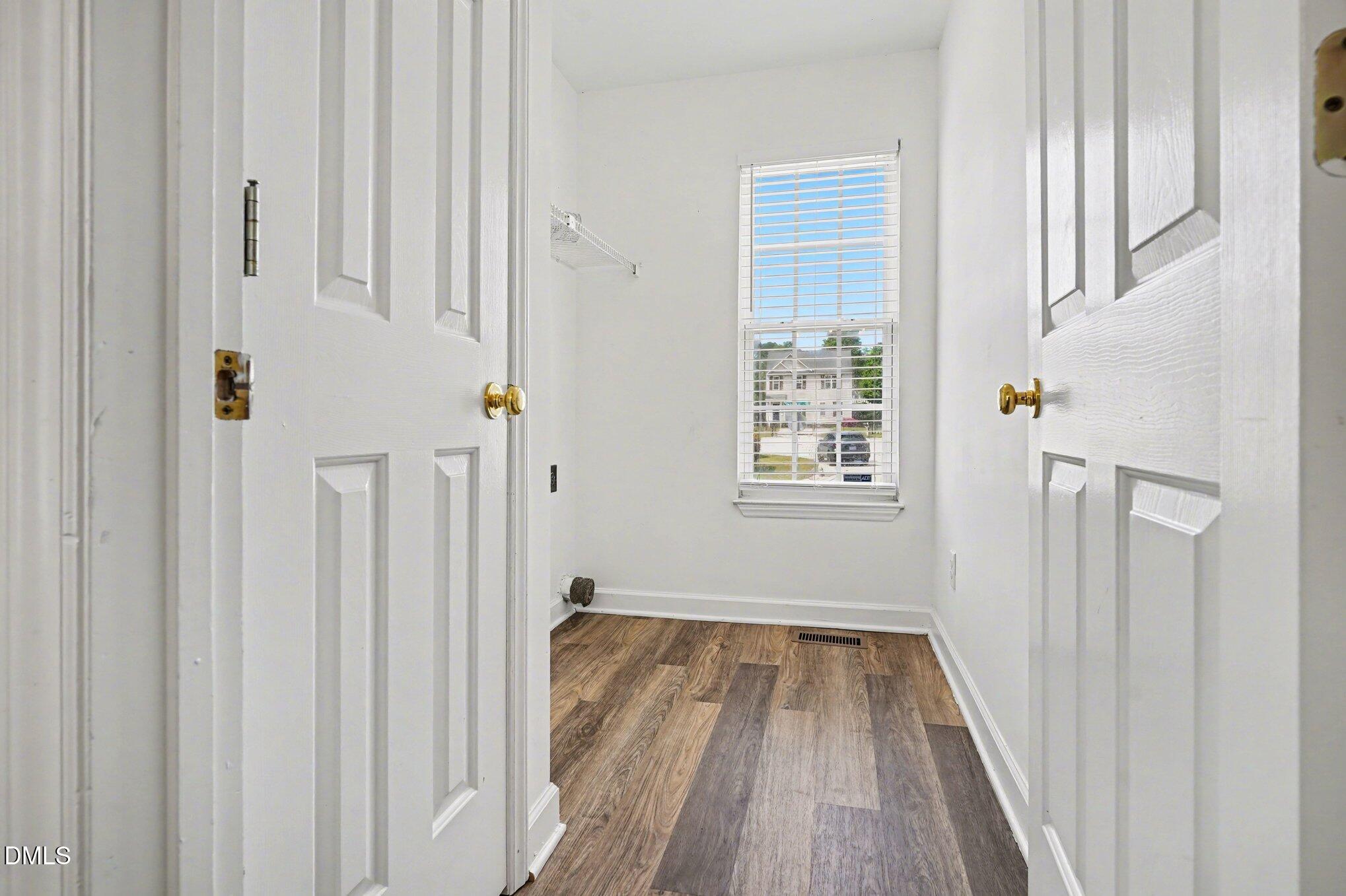 1237 Swingline Way Raleigh, NC 27610 - Photo 5 of 14 a view of a hallway with wooden floor and staircase