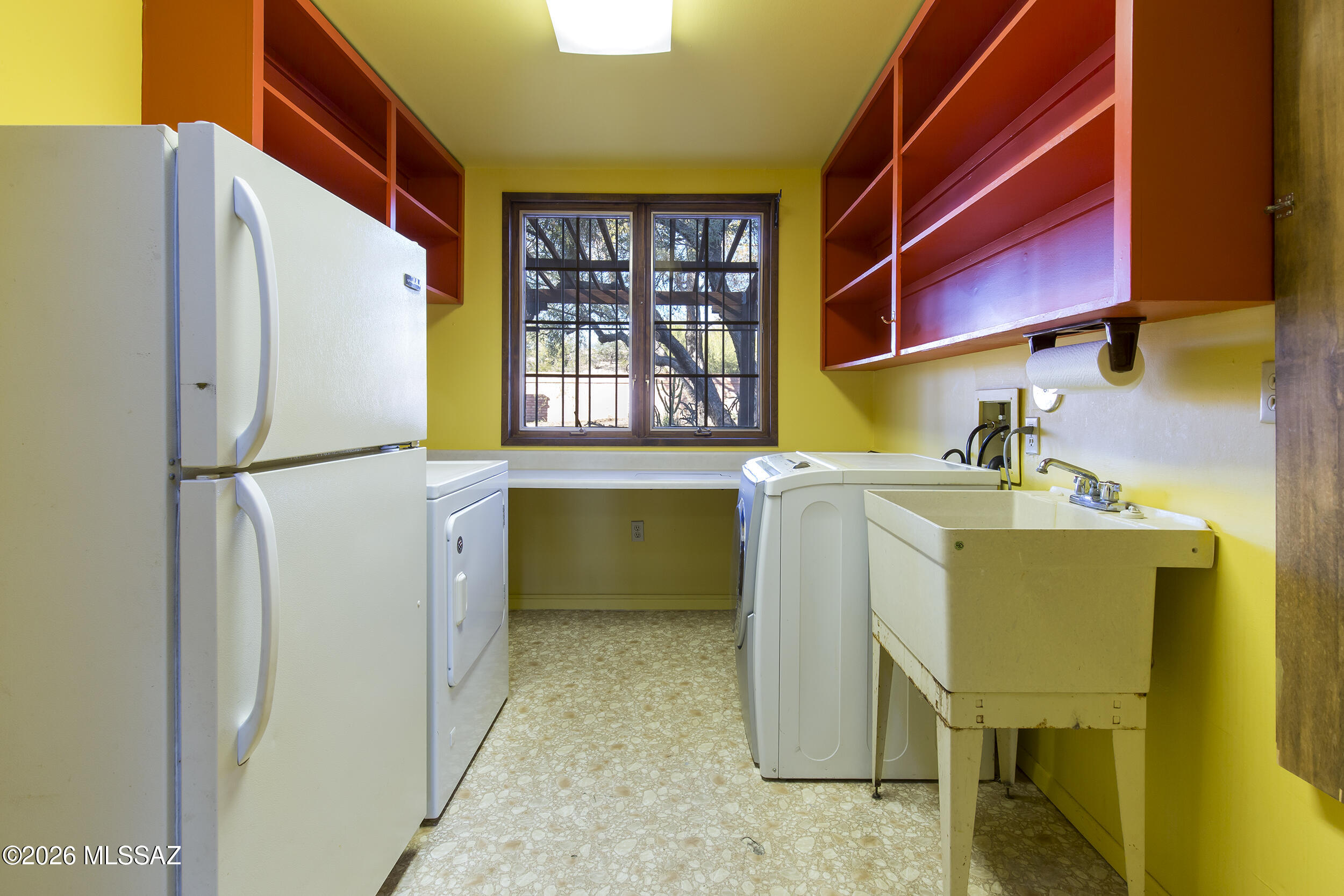 4130 East River Road Tucson, AZ 85718 - Photo 24 of 46 a utility room with a sink and a refrigerator