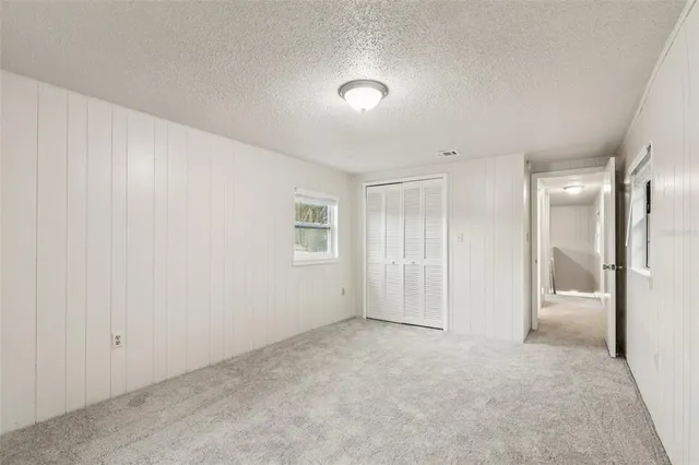 en empty room with windows and bathroom view