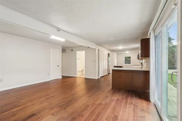 a view of a kitchen with wooden floor and a sink