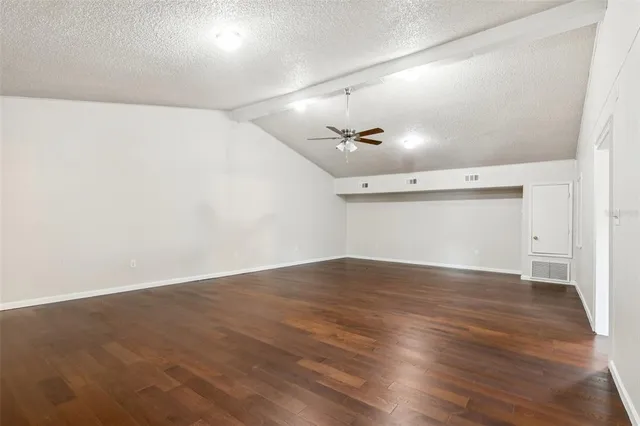an empty room with wooden floor