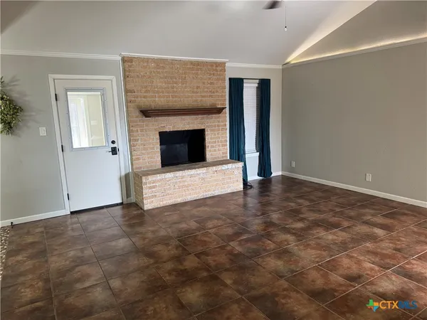 a view of an empty room with a fireplace