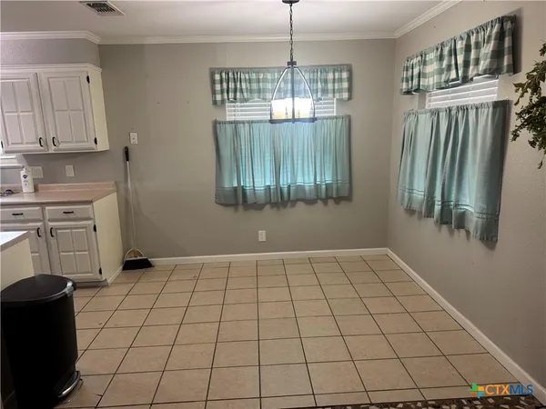 a view of an empty room with a kitchen