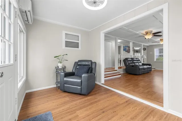 a living room with furniture and a wooden floor