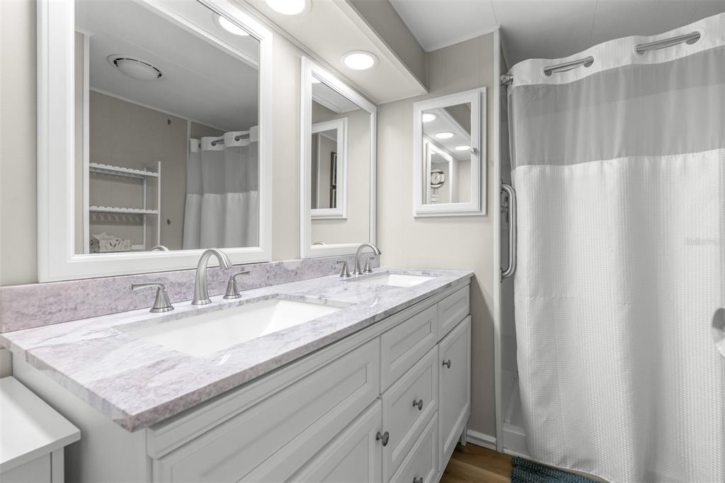 9936 East Perch Court Inverness, FL 34450 - Photo 18 of 30 a bathroom with a granite countertop sink and a mirror