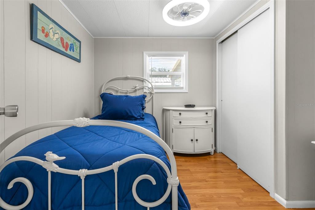 9936 East Perch Court Inverness, FL 34450 - Photo 19 of 30 a bedroom with a bed and a chandelier