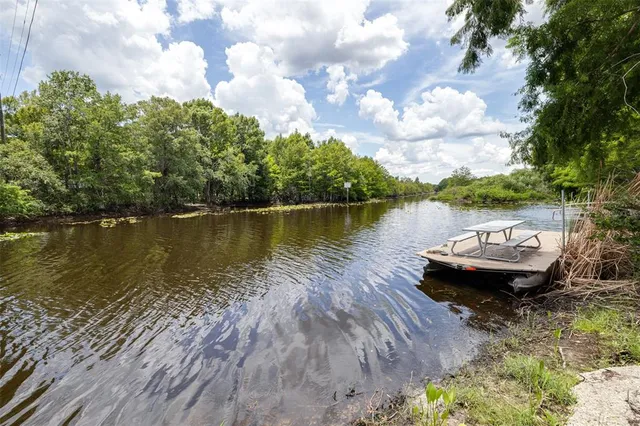 a view of a lake with houses in the back