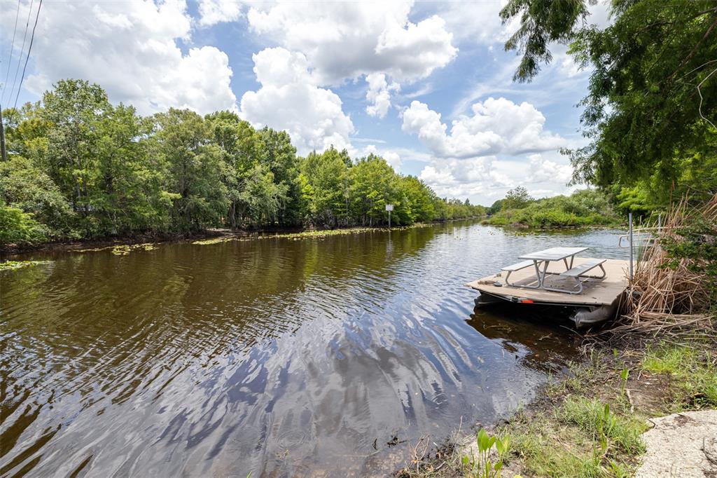 9936 East Perch Court Inverness, FL 34450 - Photo 23 of 30 a view of a lake with houses in the back