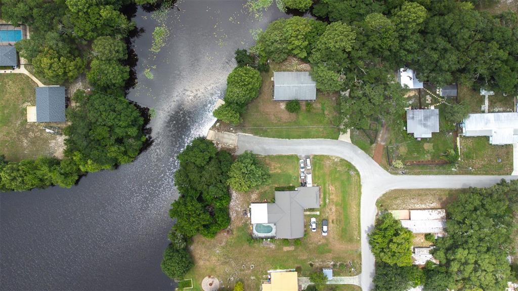 9936 East Perch Court Inverness, FL 34450 - Photo 25 of 30 an aerial view of a house with a yard potted plants and large tree