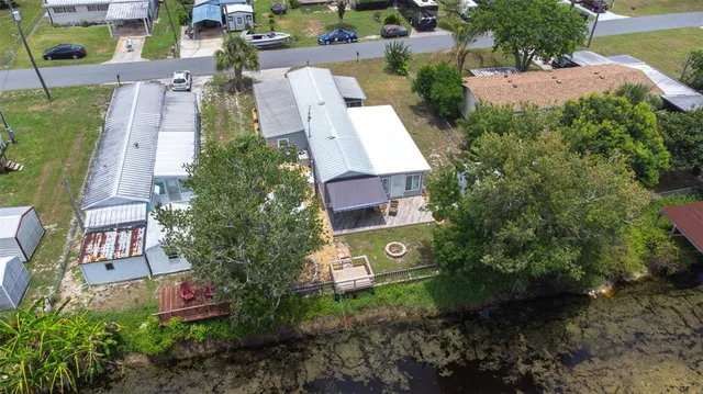 an aerial view of a house with a yard and garden