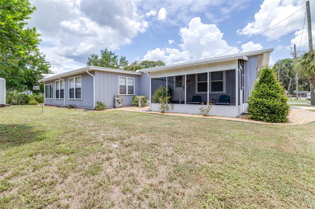 9936 East Perch Court Inverness, FL 34450 - Photo 7 of 30 a front view of a house with a yard and potted plants