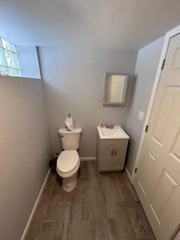 a white toilet sitting next to a bathroom sink