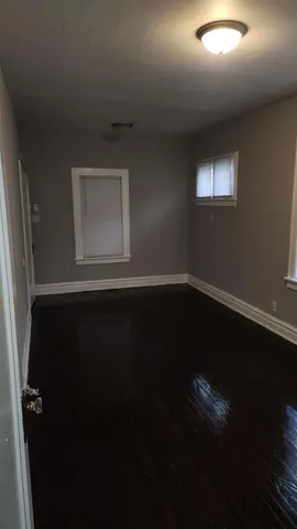 view of empty room with wooden floor and fan