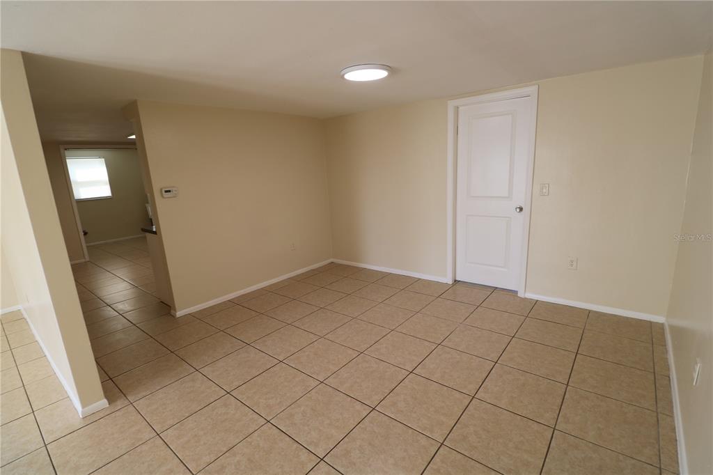 7825 Birchwood Drive Port Richey, FL 34668 - Photo 11 of 43 a view of an empty room and wooden floor