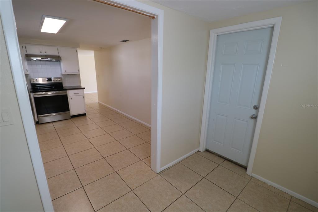 7825 Birchwood Drive Port Richey, FL 34668 - Photo 16 of 43 a kitchen with white cabinets and appliances