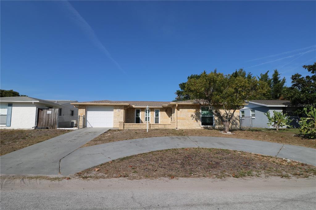 7825 Birchwood Drive Port Richey, FL 34668 - Photo 2 of 43 front view of a house with a yard