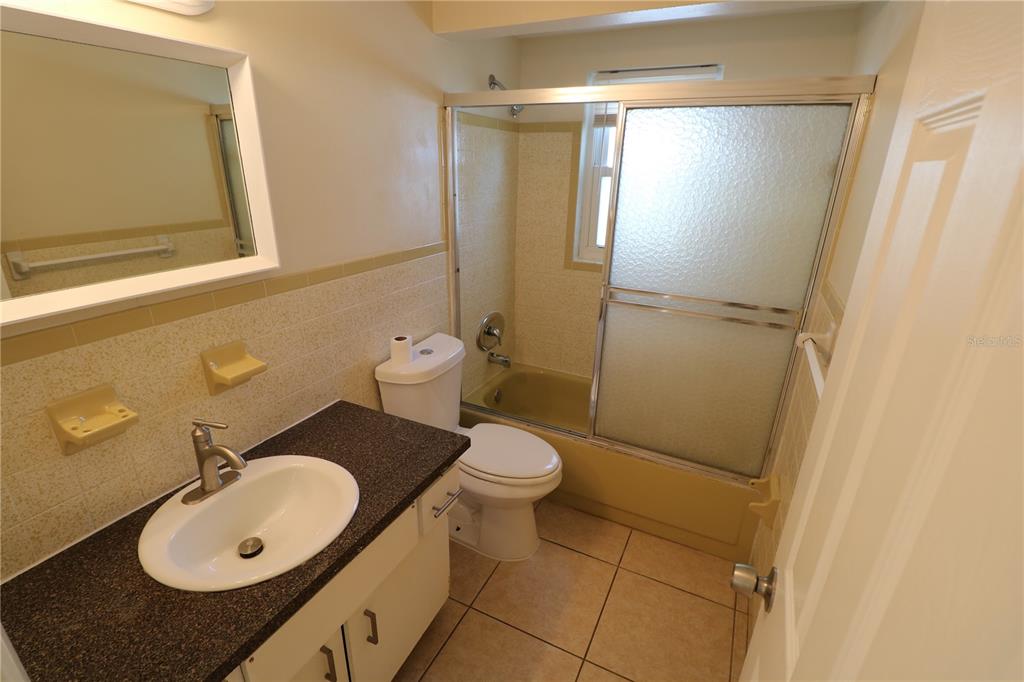 7825 Birchwood Drive Port Richey, FL 34668 - Photo 25 of 43 a bathroom with a granite countertop sink toilet and shower