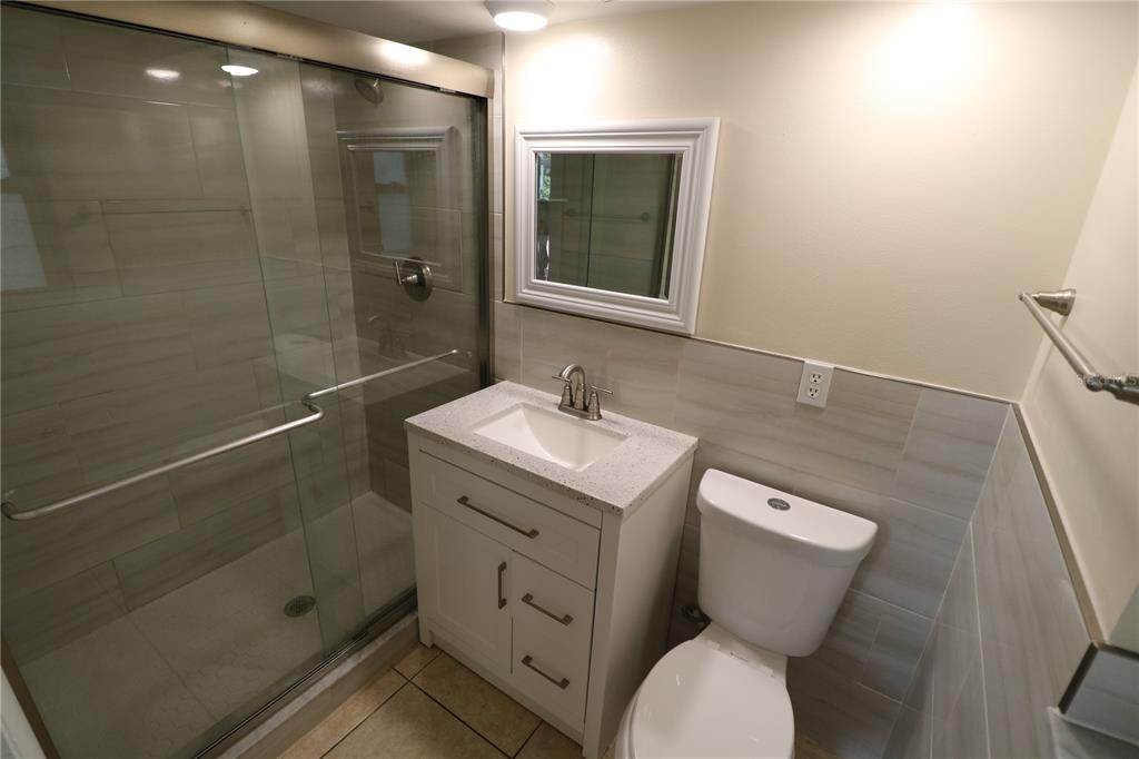 7825 Birchwood Drive Port Richey, FL 34668 - Photo 31 of 43 a bathroom with a toilet sink and shower