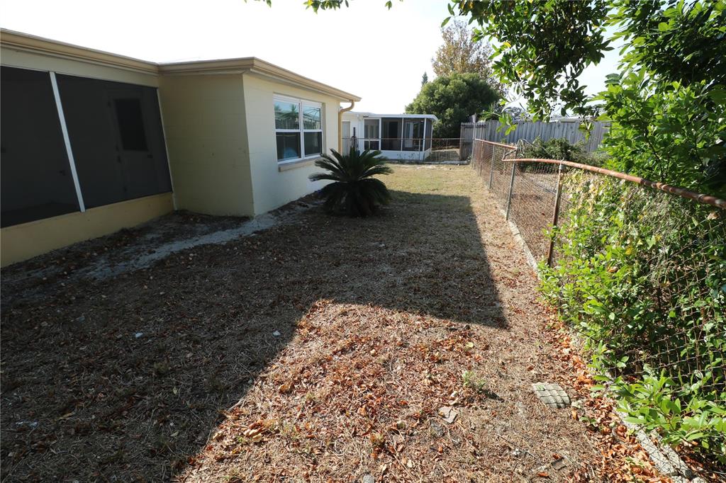7825 Birchwood Drive Port Richey, FL 34668 - Photo 41 of 43 a view of a backyard with sitting area